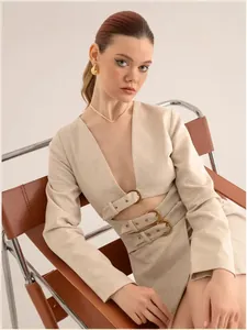 Elegant beige linen-like two-piece set with buckle details and stylish waist cutouts