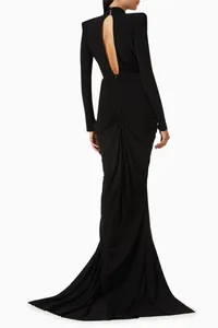 Back view of black long-sleeve evening gown with open back and ruched fishtail detail