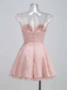 Detailed back view of pink spaghetti strap satin dress with tulle lining