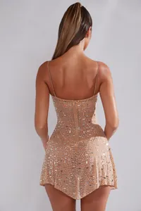 Back view of a nude sheer mini dress featuring shimmering silver rhinestones and thin straps.