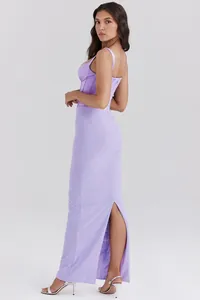 Side view of an elegant lavender corset maxi dress featuring a high back slit detail