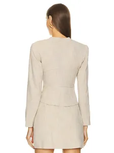 Back view of elegant beige long-sleeve blazer and mini skirt set with textured fabric