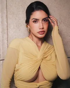 Close-up of sexy pale yellow long sleeve dress with front twist and cutout detail