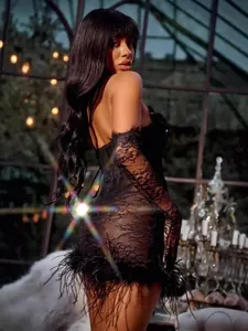 Close-up of black lace see-through dress featuring delicate feather trim and gloves