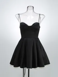 Elegant black satin camisole dress with white lace trim and flared mesh lined skirt detail.