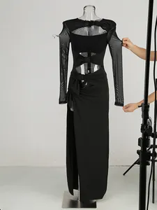 Close-up detail of black mesh long sleeve dress with high slit and cutout design