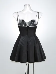 Back view of a black spaghetti strap dress with lace trim and mesh lining
