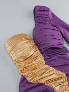 Detail of purple and gold ruched one-shoulder party dress with metallic texture