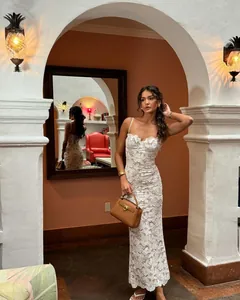 Elegant white lace camisole maxi dress featuring floral hollow patterns for formal evening wear