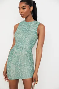Detailed view of a sleeveless mesh ruched bodycon mini dress with green marble print