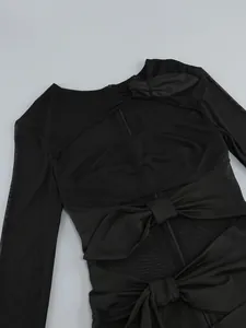 Detailed macro view of black mesh dress featuring bow knots and sexy cut-out design