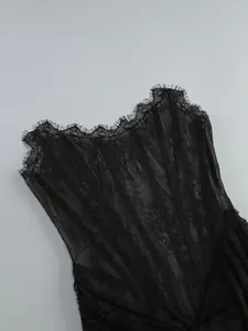 Detailed view of elegant black sheer lace corset dress with eyelash trim and boning
