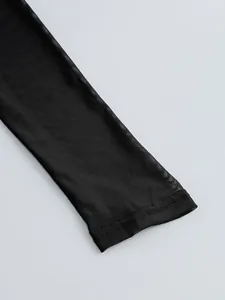 Detail shot of a sexy black sheer mesh sleeve focusing on the fine fabric texture