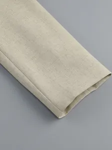 Detailed macro view of the beige long sleeve cuff showing premium fabric texture and stitching