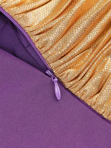 Macro view showing the purple invisible zipper and gold pleated glitter fabric detail