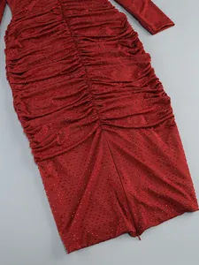 Detailed close-up of a ruched burgundy dress with sparkling rhinestone embellishments.