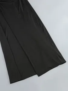 Close-up detail of a sexy black high-slit dress skirt showing the elegant fabric drape