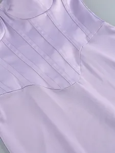 Detailed macro view of purple mesh and satin-like corset panels of an elegant dress