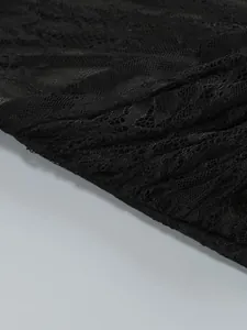 Macro view showing the intricate floral patterns of black lace on an elegant evening dress