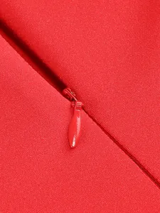 Detailed close-up shot of the high-quality invisible red zipper on an elegant evening dress