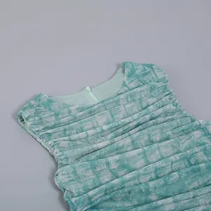 Close-up of teal green mesh dress featuring intricate ruched details and back zipper.