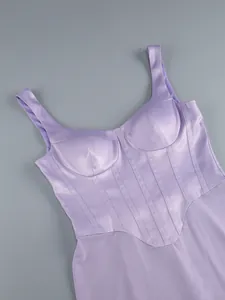 Close-up detail of purple satin corset bodice with structured cups and boning seams