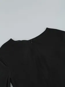 Detailed macro shot showing back invisible zipper and mesh fabric of a black dress