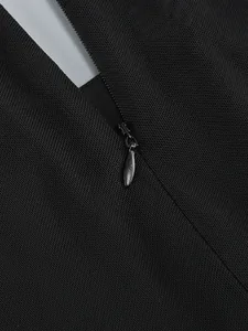 Close-up detail of the invisible zipper on a black mesh long-sleeved formal dress