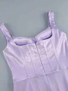 Close-up detail of a lavender satin evening dress back with hidden zipper and vertical seams.