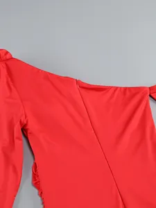 Detail view of a vibrant red slim-fit dress showing invisible zipper and pleated texture.