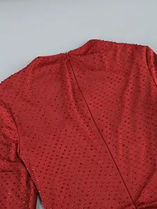 Close-up of red rhinestone dress detailing with back zipper and sparkling finish