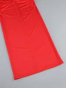 Close-up of vibrant red slim-fit midi dress hemline showing high-quality fabric texture