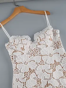 Detailed close-up showing the intricate white floral lace and jacquard on a camisole dress