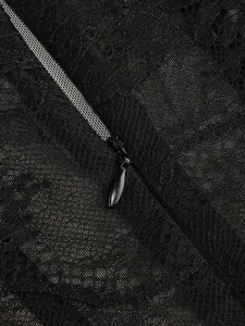 Macro view showing the intricate black lace texture and invisible zipper on the dress
