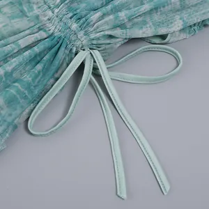 Macro view of mesh fabric texture and adjustable drawstring detail on sheer dress