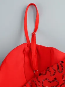 Close-up detail of red evening dress showing adjustable shoulder straps and sequin mesh texture