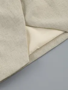 Macro detail of the high-quality linen-like fabric texture and lining of the women's skirt set