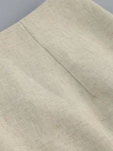 Close-up of the breathable linen-textured beige fabric for women's two-piece suit.