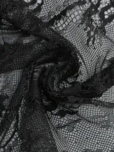 Close-up of intricate black lace fabric texture for elegant evening dress detail