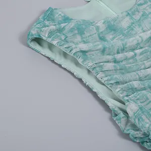 Detail view of light green mesh dress showing ruched fabric and marble print texture