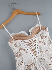 Exquisite close-up of white floral lace dress featuring an elegant corset lace-up back detail