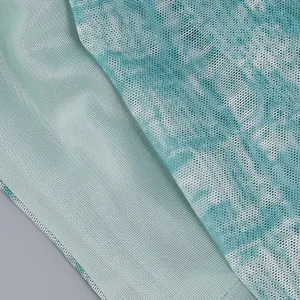 Detailed macro view showing the fine texture of sheer teal mesh fabric with white patterns