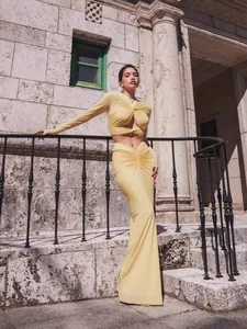 Elegant yellow two-piece dress set with long sleeves and stylish twist knot design