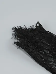 Close-up of delicate black eyelash lace detail on the sleeve of an elegant evening dress