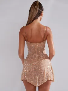 Back view of elegant nude spaghetti strap mini dress with sparkly rhinestone details