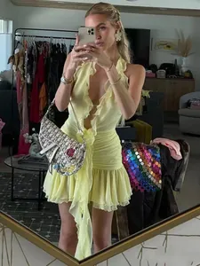 Yellow halter ruffle dress with pleated details shown in a lifestyle mirror selfie