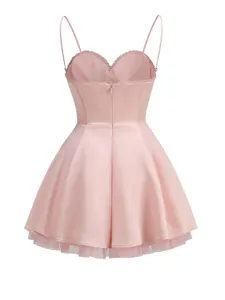Back view of a pink satin cocktail dress with spaghetti straps and tulle lining detail.