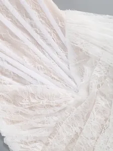Detailed macro view of an elegant white lace evening dress showing corset structure