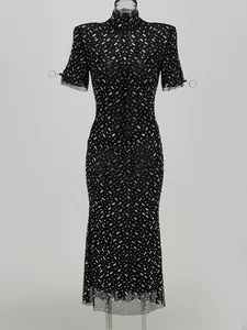 Elegant black fishtail evening dress featuring sparkling rhinestones and a high neck design