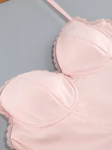 Close-up of elegant pink satin cocktail dress showing delicate lace trim and structured cups